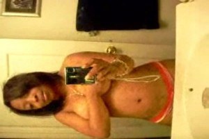 A busty ebony chick filming herself in the bathroom