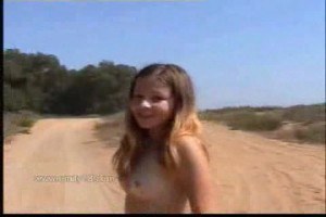 Young and sweet Emily in nature topless walking