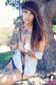 Tempestuous babe with awesome tattoos teases with cleavage 