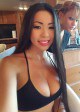 Busty Asian babe presents her generous cleavage