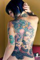 Tattooed emo chick shows her back