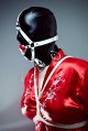 Gagged sub wears a leather mask