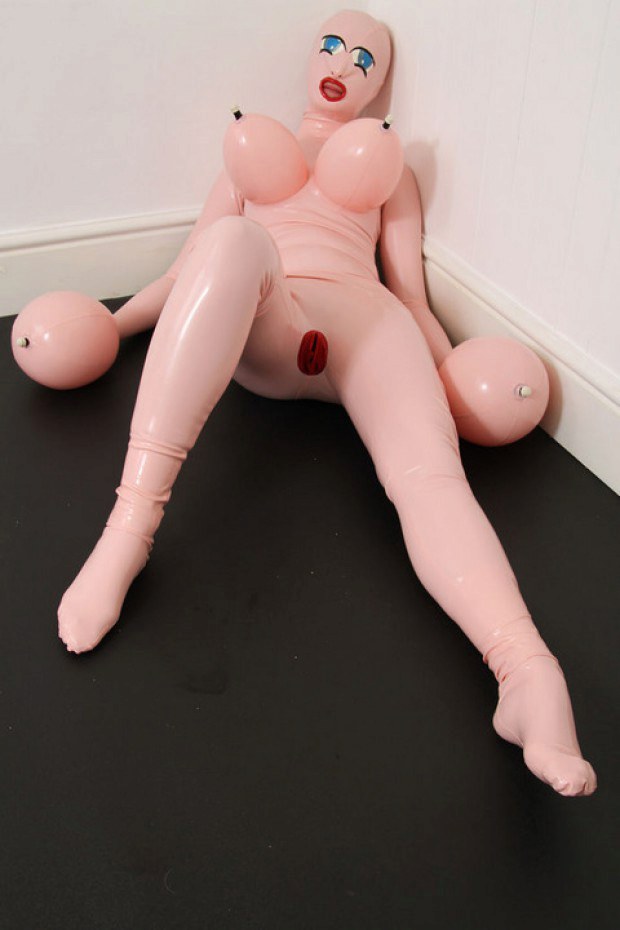 fetish sub wearing a latex inflatable doll. 