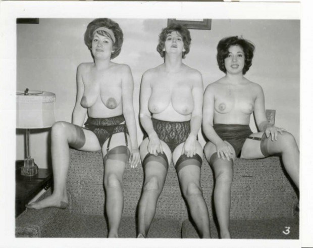 Three vintage wives are topless on the sofa