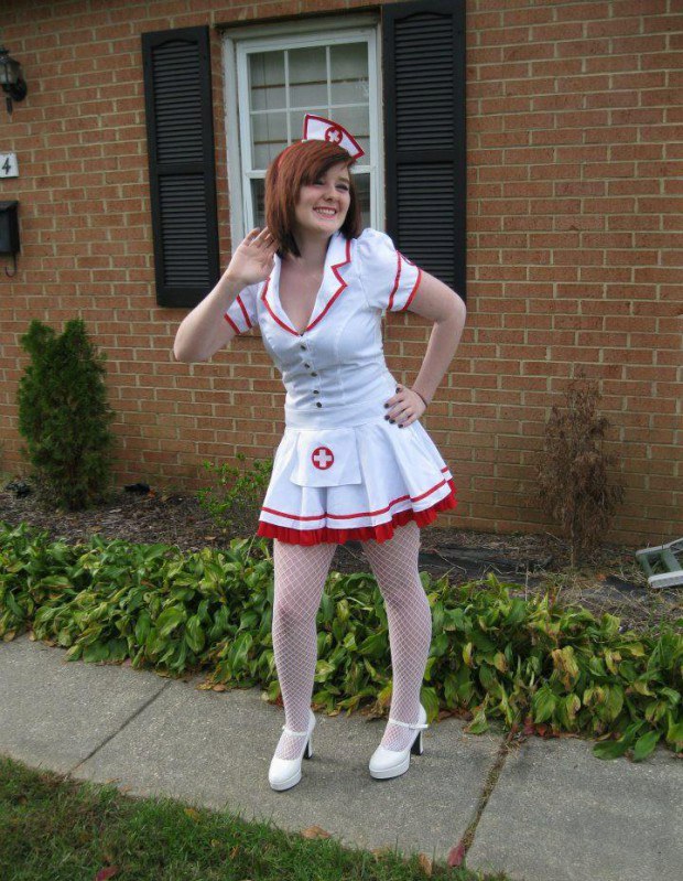 Kinky redhead nurse poses outdoors