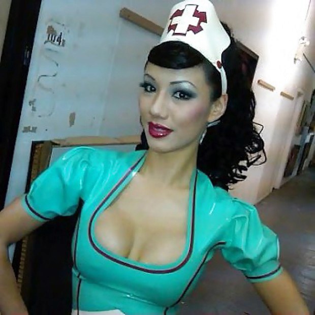 Busty Asian nurse in PVC costume has a nice cleavage