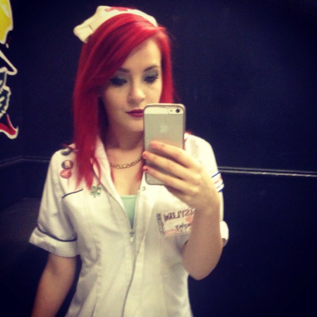 Redhead nurse takes a selfie in her uniform
