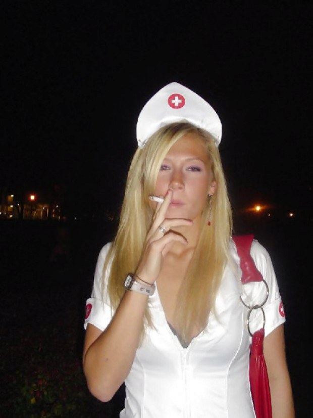 Blonde nurse smokes a cigarette outdoors
