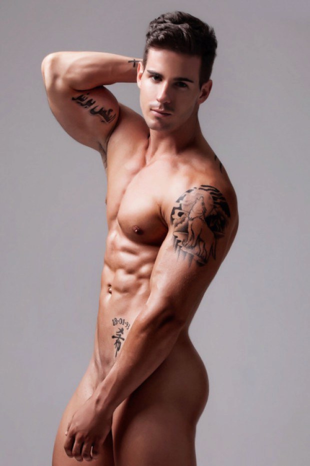 Inked gay model poses sexy for the magazine