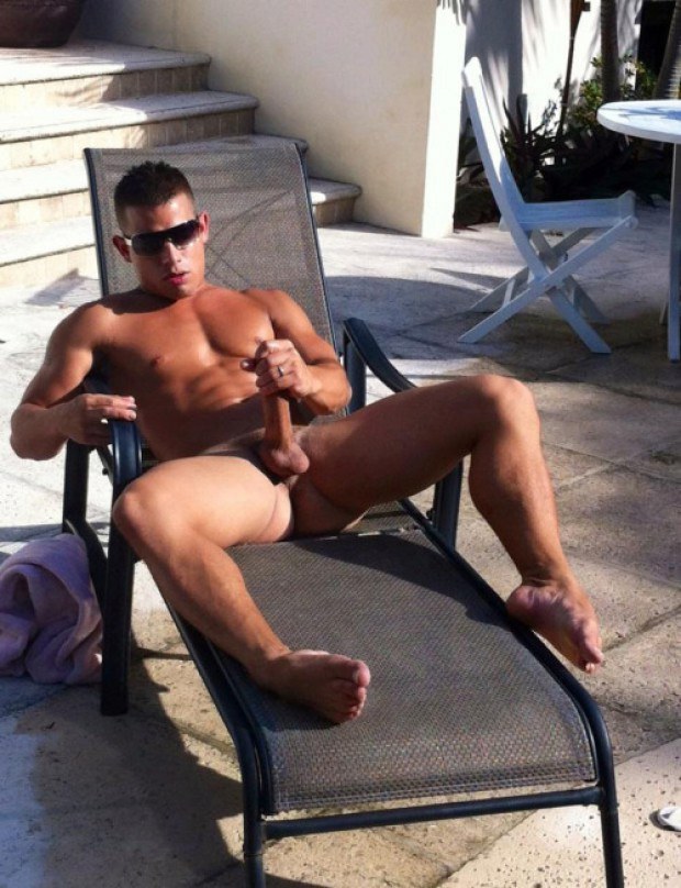 Gay stud with sunglasses polishes the rod outdoors