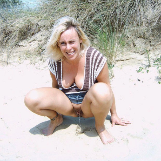 Busty wife pees at the beach photo