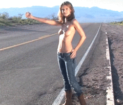 Topless beauty hitchhiking on the side of the road