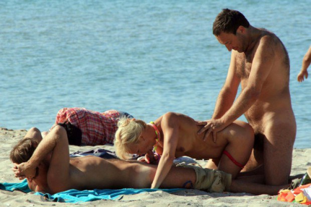 Swinger wife shared on the beach between two men