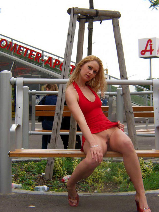 European blonde shows upskirt on the public bench