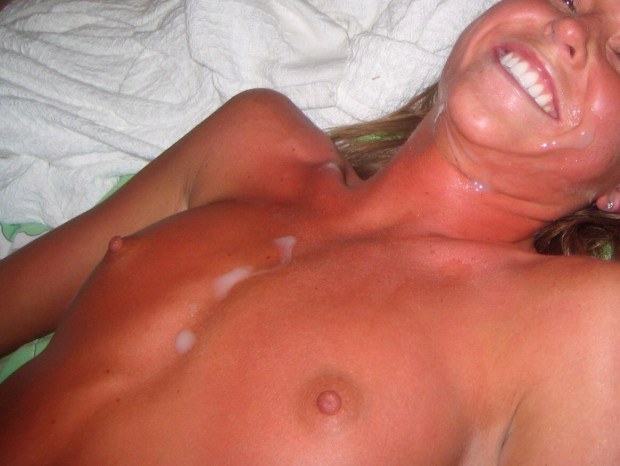 Wife smiles after getting cum all over her face and body photo