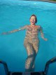 Naked mature laughs in the pool