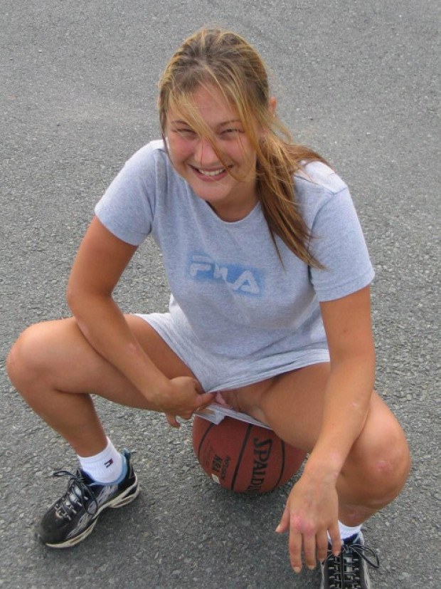 Teen shows her shaved pussy through basketball shorts